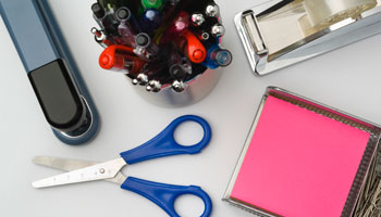office supplies scissor stapler pens tape pencils table